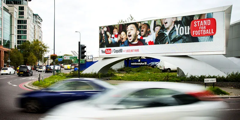 Roadside digital billboard beside a busy junction