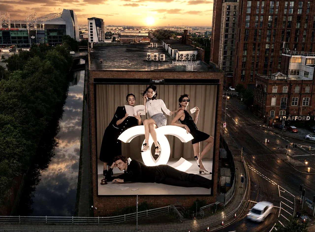 The Manchester Screen at dusk, showing a Chanel campaign