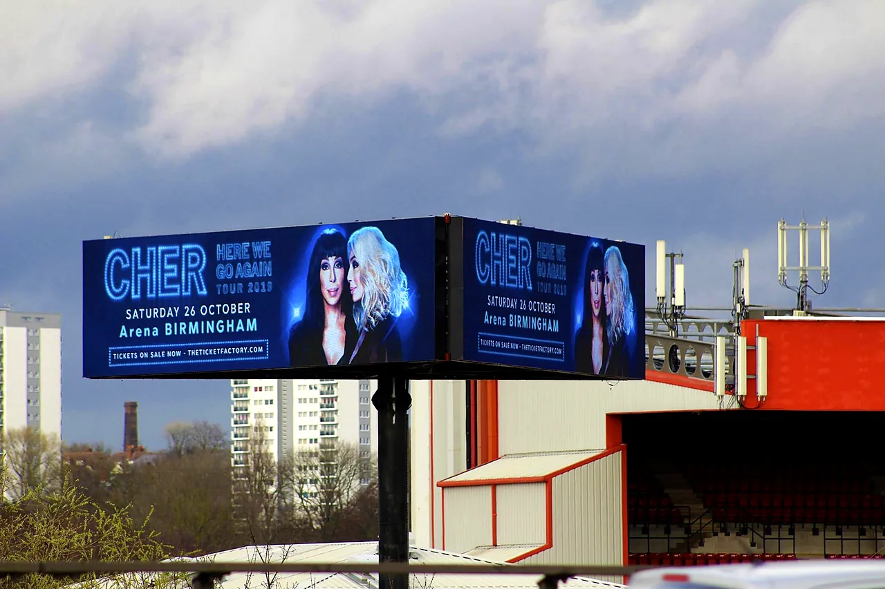 Large LED advertising screen at Walsall FC's ground, with the stand behind